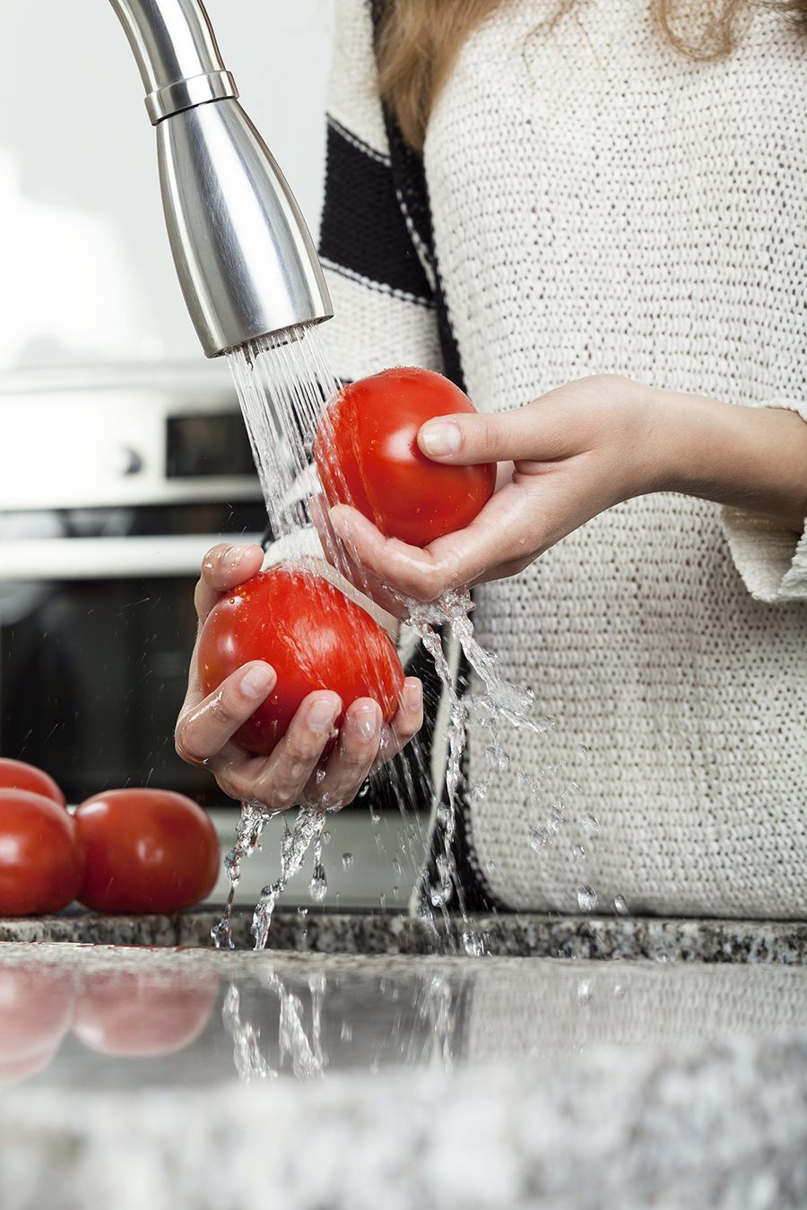 Washing tomatoes under the tap