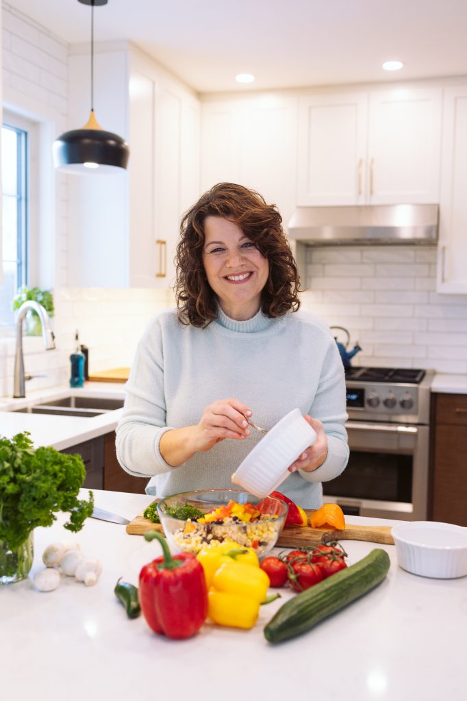 A portrait shot of Getty Stewart, professional home economist, in her kitchen